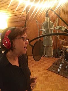 Judy Rodman singing at studio mic