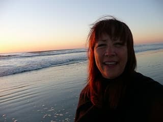 Judy in twilight by the calm ocean