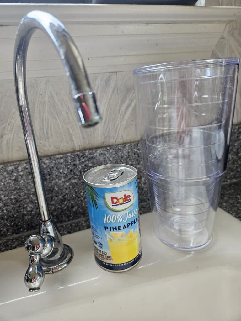 Pineapple juice can and water glass